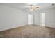 Bedroom with beige carpet, ceiling fan, and two closets at 353 Spearhead Pl, Clayton, NC 27520