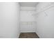 Walk-in closet with white wire shelving and beige carpet at 353 Spearhead Pl, Clayton, NC 27520