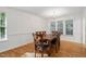 Cozy dining room featuring hardwood floors, chandelier, and natural light at 353 Spearhead Pl, Clayton, NC 27520