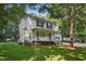 Beautiful two-story home featuring a cozy front porch and well-maintained landscaping at 353 Spearhead Pl, Clayton, NC 27520