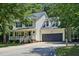 Charming two-story home with a welcoming front porch and attached two-car garage at 353 Spearhead Pl, Clayton, NC 27520