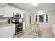 Bright kitchen with stainless steel appliances and a wooden kitchen island next to a bay window at 353 Spearhead Pl, Clayton, NC 27520
