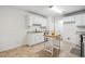 Bright kitchen with white cabinets, tile flooring, stainless steel dishwasher, and a wooden kitchen island at 353 Spearhead Pl, Clayton, NC 27520