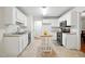 Bright kitchen with white cabinets, tile flooring, stainless steel appliances, and a wooden kitchen island at 353 Spearhead Pl, Clayton, NC 27520