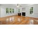 Spacious living room with hardwood floors, fireplace, and plenty of natural light at 353 Spearhead Pl, Clayton, NC 27520