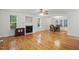 Open floor plan featuring a fireplace, hardwood floors, and adjacent dining area at 353 Spearhead Pl, Clayton, NC 27520