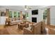 Bright living room featuring a fireplace, hardwood floors, and natural light at 353 Spearhead Pl, Clayton, NC 27520
