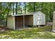 An exterior shot of a backyard shed with an open lean-to and enclosed storage area at 353 Spearhead Pl, Clayton, NC 27520