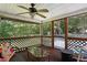 Relaxing screened porch with rustic decor, ceiling fan, and outdoor views at 353 Spearhead Pl, Clayton, NC 27520