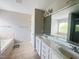 Bathroom with double sinks, a soaking tub, and white cabinetry at 3927 Wedonia Dr, Cary, NC 27519