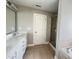 Bathroom featuring double sinks, tiled floors, a glass shower, and white cabinets at 3927 Wedonia Dr, Cary, NC 27519