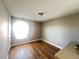 Bright bedroom with hardwood floors, neutral paint, and a window letting in lots of light at 3927 Wedonia Dr, Cary, NC 27519