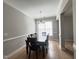 Formal dining room featuring an elegant chandelier, large window, and hardwood floors at 3927 Wedonia Dr, Cary, NC 27519