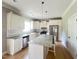 Bright kitchen with a center island, stainless steel appliances, and white cabinets at 3927 Wedonia Dr, Cary, NC 27519