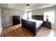 Spacious primary bedroom with hardwood floors, a ceiling fan, and large windows at 3927 Wedonia Dr, Cary, NC 27519