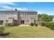 Lush backyard featuring a patio, green lawn, and privacy fence with hanging flower baskets at 401 Dyersville Dr, Morrisville, NC 27560