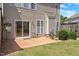 Inviting backyard with a concrete patio, lush green grass, and manicured landscaping at 401 Dyersville Dr, Morrisville, NC 27560
