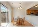 Charming dining room with a classic table set, hardwood floors, and sliding glass door at 401 Dyersville Dr, Morrisville, NC 27560
