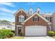 Charming brick townhome featuring a two-car garage and manicured front yard at 401 Dyersville Dr, Morrisville, NC 27560