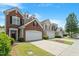 View of townhomes with well-maintained lawns and driveways on a sunny day at 401 Dyersville Dr, Morrisville, NC 27560