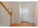 Welcoming foyer with hardwood floors, wainscoting, and decorative front door at 401 Dyersville Dr, Morrisville, NC 27560