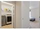Laundry room with front-loading washer and dryer and shelves at 401 Dyersville Dr, Morrisville, NC 27560