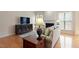 Spacious living room featuring hardwood floors and a large flat-screen TV at 401 Dyersville Dr, Morrisville, NC 27560