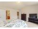 Bright main bedroom featuring a floral comforter and dark wood furniture at 401 Dyersville Dr, Morrisville, NC 27560