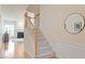 Carpeted staircase with wooden banister leading to the upper level at 401 Dyersville Dr, Morrisville, NC 27560