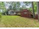 Expansive backyard showcasing a spacious deck and lush green lawn, ideal for outdoor activities at 4030 King Charles Rd, Durham, NC 27707
