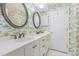 Bathroom with dual sinks, floral wallpaper, and vintage-style fixtures at 4030 King Charles Rd, Durham, NC 27707