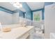 The spacious bathroom has ample vanity countertop, window and combination tub and shower at 4030 King Charles Rd, Durham, NC 27707