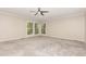 Neutral bedroom with soft carpet, and corner windows offering natural light at 4030 King Charles Rd, Durham, NC 27707
