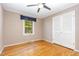 Cozy bedroom with hardwood floors, ample natural light, and a ceiling fan for optimal comfort at 4030 King Charles Rd, Durham, NC 27707