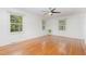 Bright bedroom with hardwood floors, large windows, and a ceiling fan at 4030 King Charles Rd, Durham, NC 27707