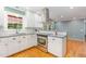 Modern kitchen featuring stainless steel appliances, granite countertops, and white cabinets at 4030 King Charles Rd, Durham, NC 27707