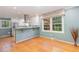 Bright kitchen with stainless steel appliances, white cabinetry, and wood floors at 4030 King Charles Rd, Durham, NC 27707