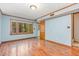 Bright living room with wood-look floors and a large window for a light filled space at 4030 King Charles Rd, Durham, NC 27707