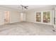 Spacious main bedroom with carpet, multiple windows, and access to a walk-in closet at 4030 King Charles Rd, Durham, NC 27707