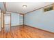 Versatile room with wood-look floors, ample lighting, and extra storage shelves at 4030 King Charles Rd, Durham, NC 27707