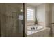 Luxurious bathroom with soaking tub, tiled shower, and decorative tile accents at 441 Heritage Village Ln, Apex, NC 27502