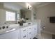 Elegant bathroom with double vanity, white cabinetry, and a large mirror at 441 Heritage Village Ln, Apex, NC 27502