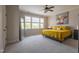 Bright bedroom with large windows, gray walls, and a king sized bed with yellow accents at 441 Heritage Village Ln, Apex, NC 27502