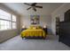 Comfortable bedroom with gray walls, ceiling fan, and a king sized bed with yellow accents at 441 Heritage Village Ln, Apex, NC 27502