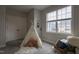 Neutral bedroom with a tent in the corner near a bright window and a full-sized bed at 441 Heritage Village Ln, Apex, NC 27502