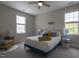 Cozy bedroom with a blue bedframe, accent chair and two large windows at 441 Heritage Village Ln, Apex, NC 27502