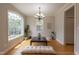 Bright dining room featuring a large window, wood floors, and elegant chandelier at 441 Heritage Village Ln, Apex, NC 27502