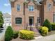 Brick townhome featuring manicured landscaping and a welcoming entrance at 441 Heritage Village Ln, Apex, NC 27502
