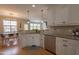 Well-equipped kitchen featuring granite countertops, stainless steel appliances and white cabinets at 441 Heritage Village Ln, Apex, NC 27502