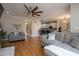Spacious living room with hardwood floors, ceiling fan, and a comfortable gray sofa at 441 Heritage Village Ln, Apex, NC 27502